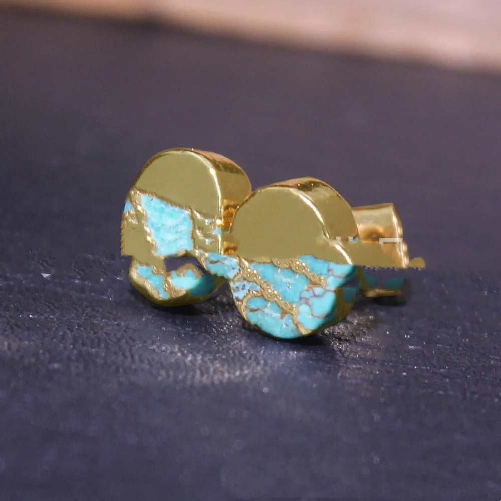 Handmade natural stone bohemian style stud earrings with an irregular organic shape on a grey background.