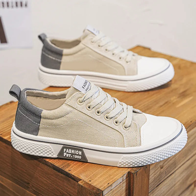 Men's low-top blue canvas skate shoes with round toe and flat heel on a white background.