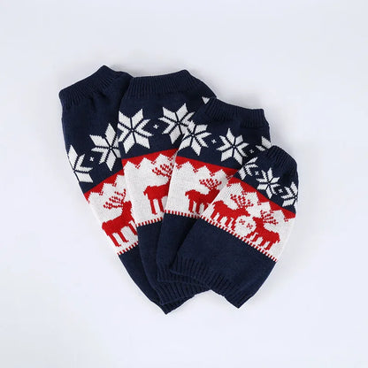 Navy blue knitted Christmas sweater for dogs on a festive background