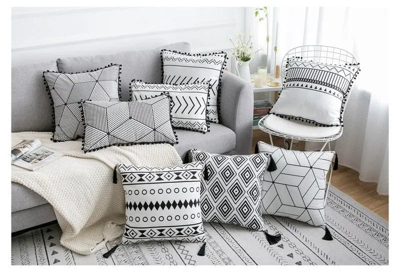 Bohemian style decorative pillowcase in light grey colour on a sofa.