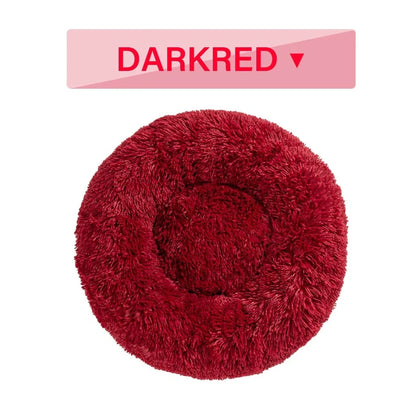 Fluffy donut-shaped dog bed in dark grey colour with raised edges, showing plush texture and circular design
