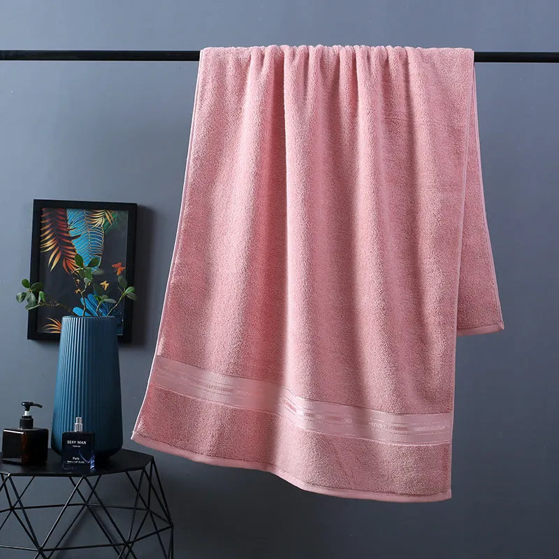 Three-piece cotton towel set showing bath towel, towel, and square scarf in coordinating colours