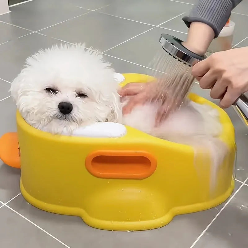 Blue PVC duck-shaped bathtub for washing a small dog or cat outdoors.