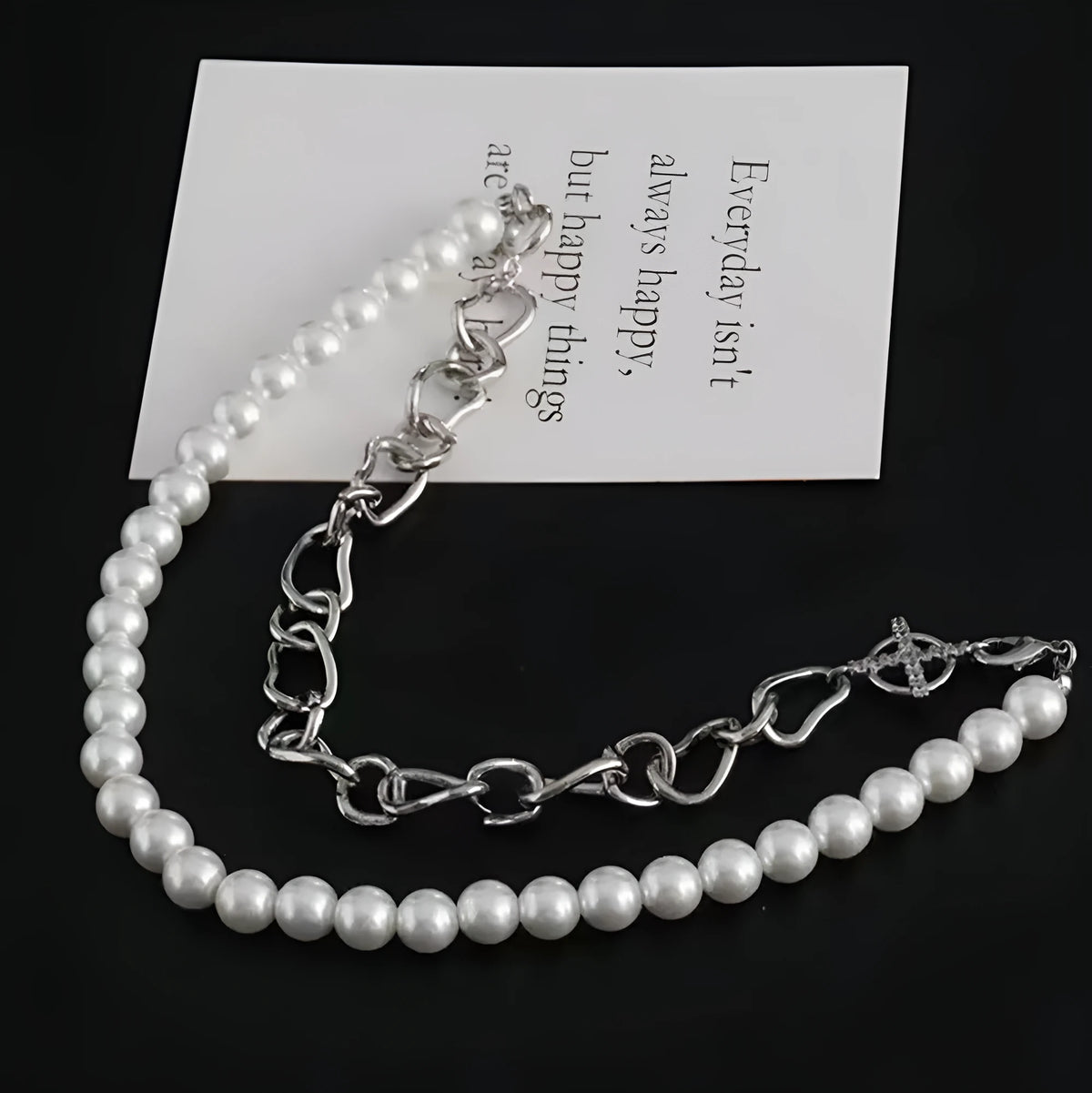 White geometric acrylic asymmetric clavicle chain necklace on a twisted chain.
