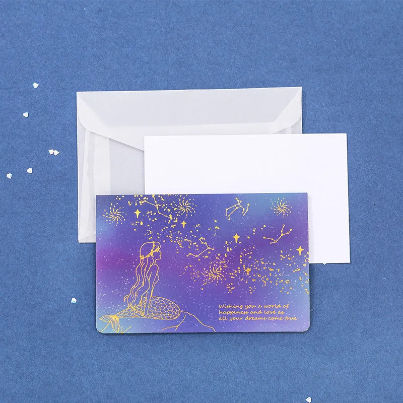 Set of three bronzing detail greeting card envelopes in cosmic colours, showing mermaid style fold.