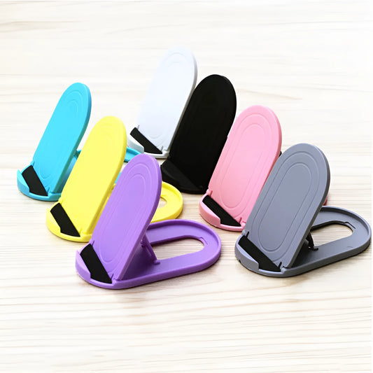 Black adjustable lazy bracket phone stand holding a mobile device at an angle on a wooden table.