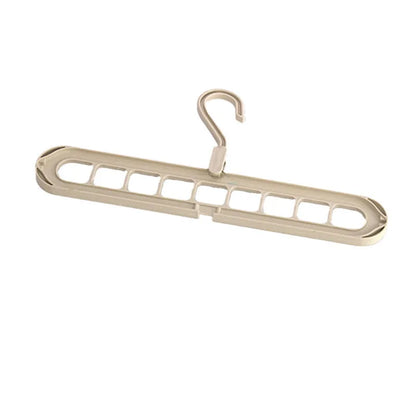Green nine-hole folding hanger with trousers organised across nine hanging points, showing 45cm width