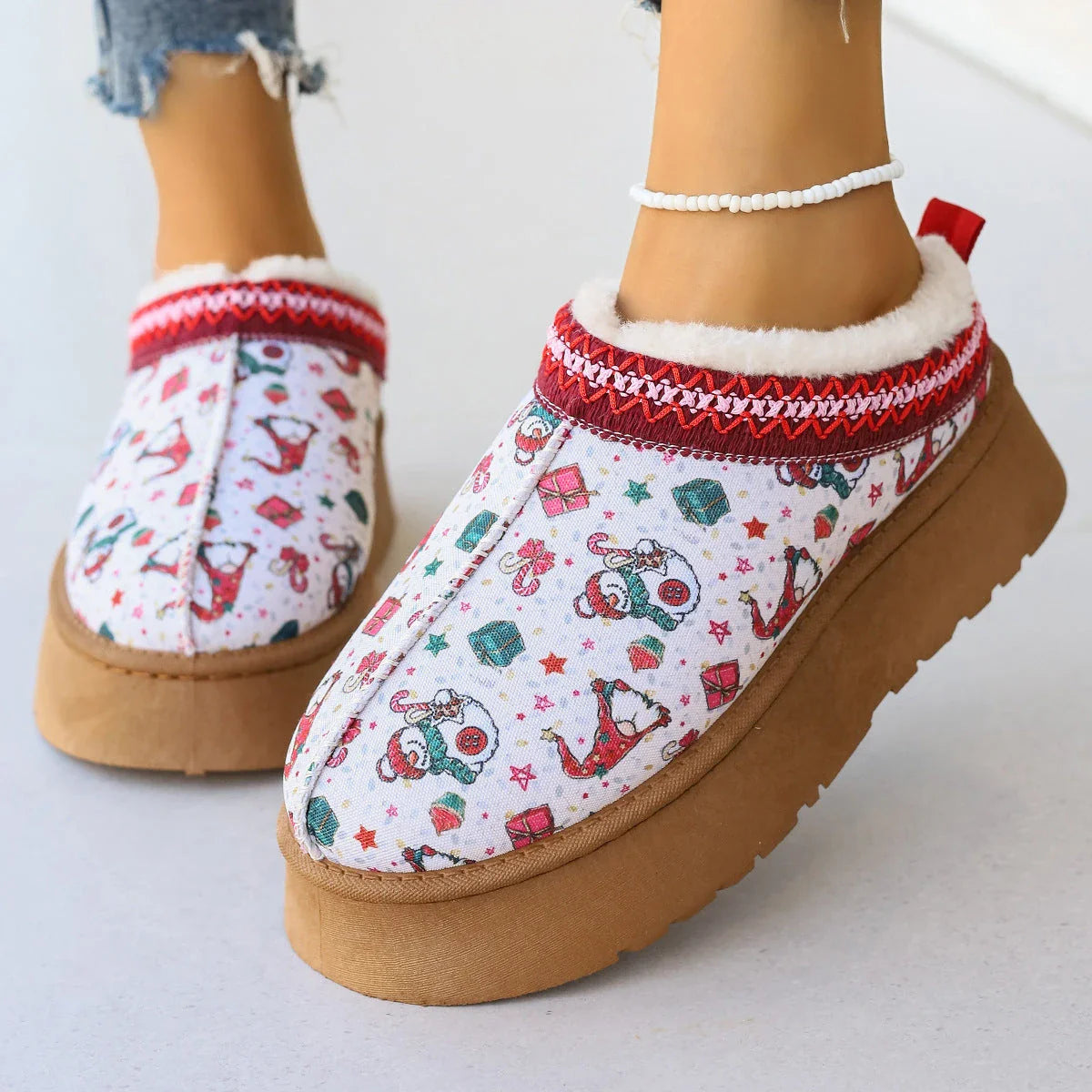 Women's winter ankle boots with festive cartoon Christmas print, plush lining, and durable EVA sole for comfortable, warm wear.