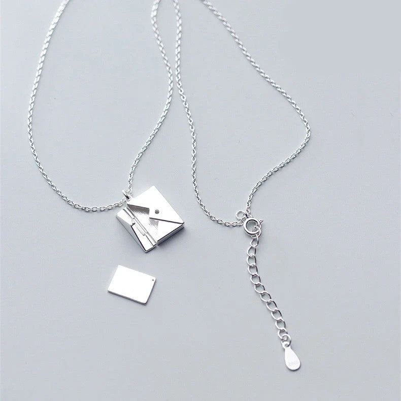 Stylish titanium steel envelope necklace with a discreet compartment for storing personal keepsakes
