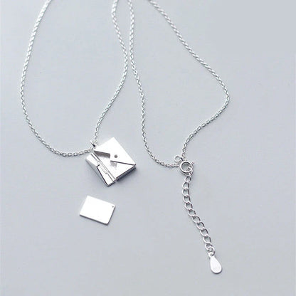 Stylish titanium steel envelope necklace with a discreet compartment for storing personal keepsakes