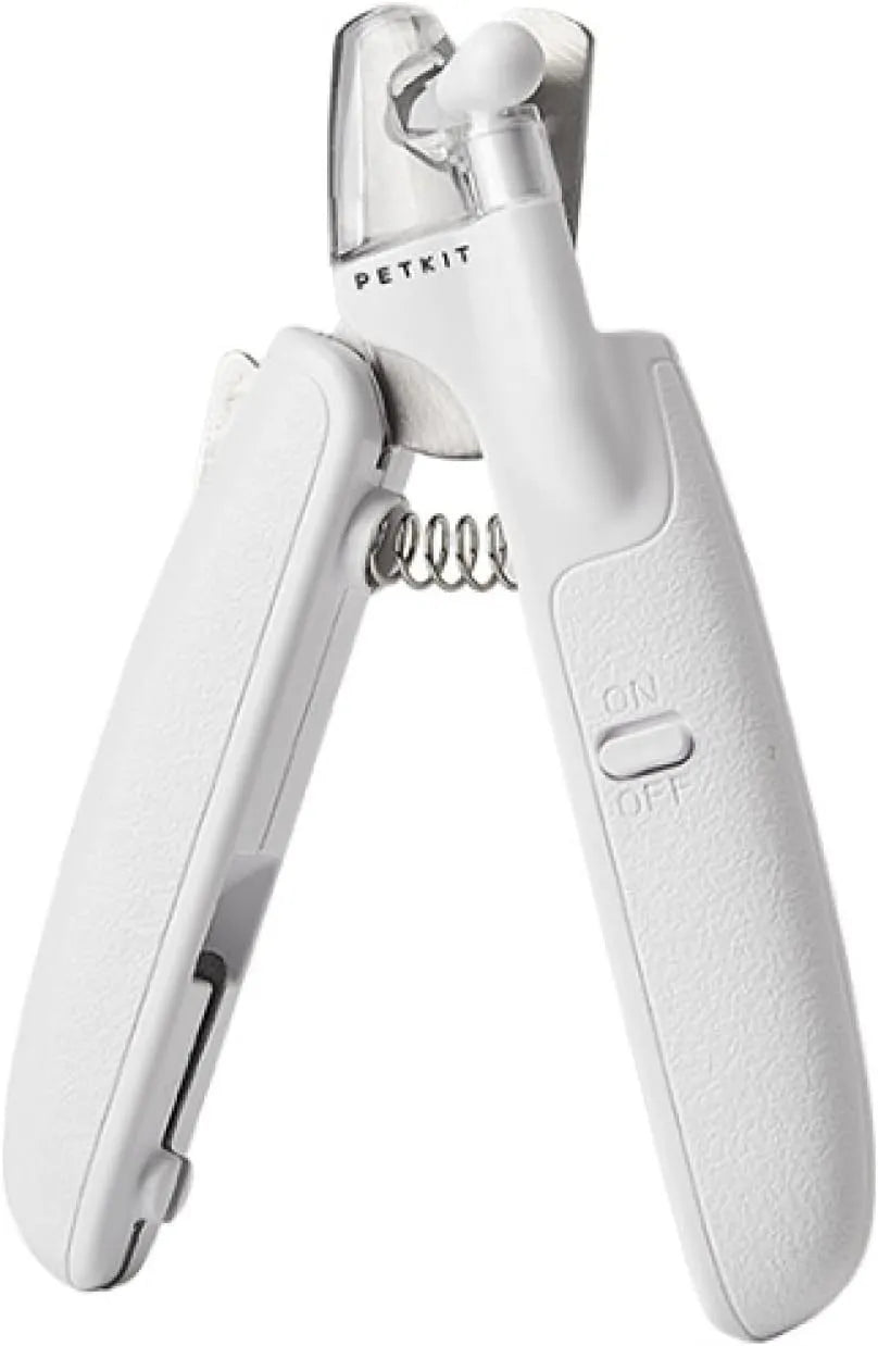 White pet nail clippers with LED light, anti-splash guard, and built-in nail file on a flat surface.
