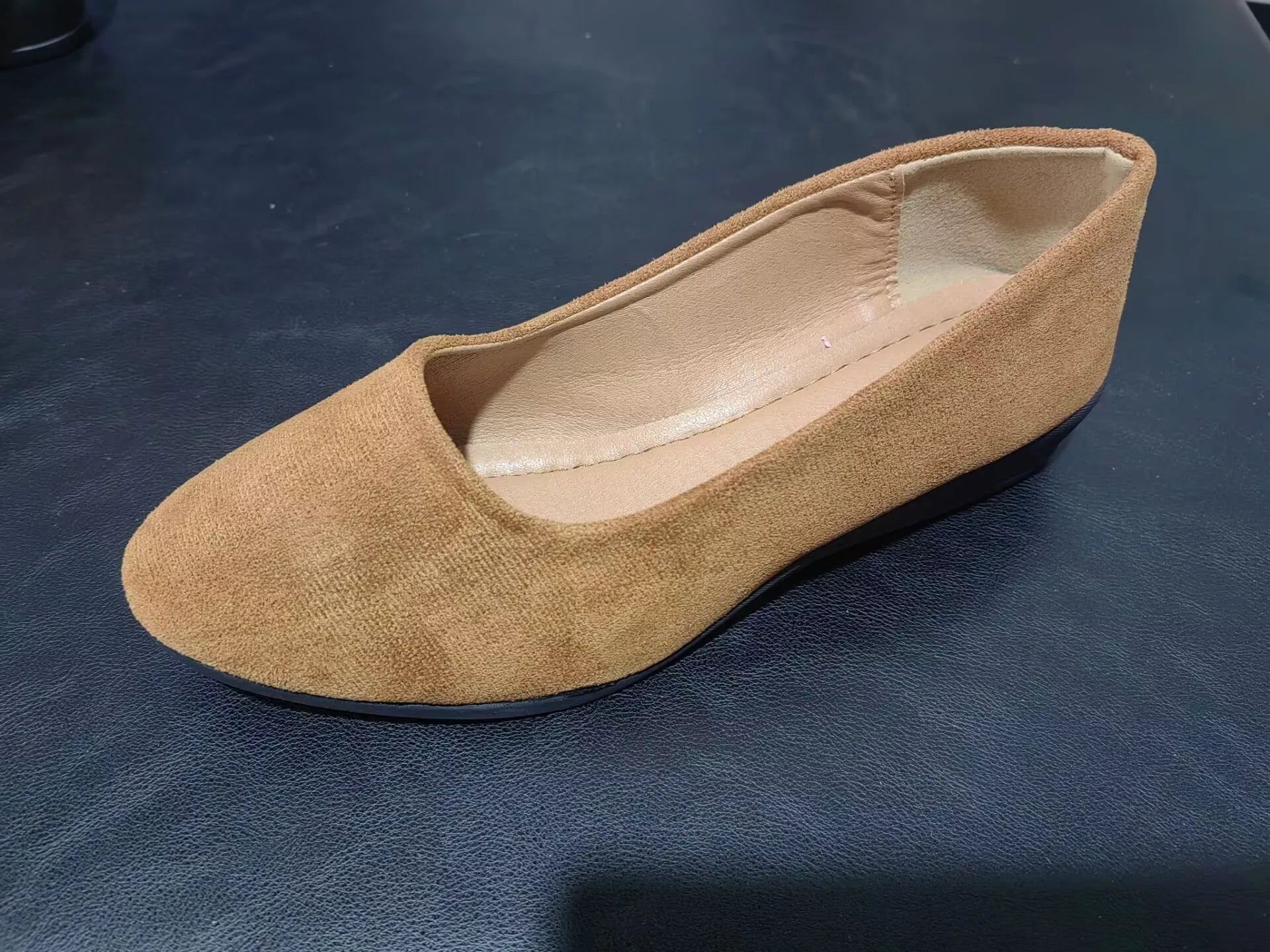 Women's black pointed toe wedge pumps with suede upper and low rubber sole