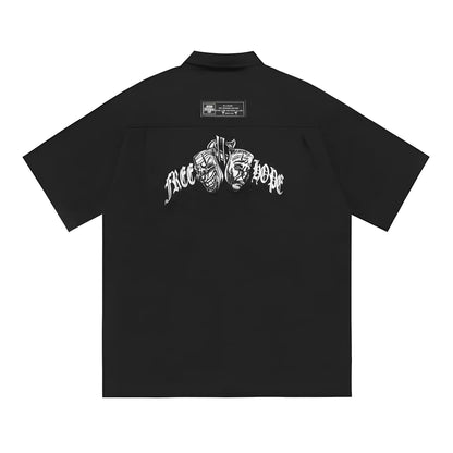 Man wearing a black cotton blend half-sleeve loose fit work shirt with embroidered detail.