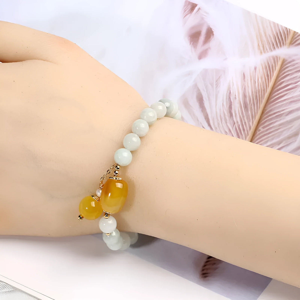 Women's ethnic bracelet with hanging red agate tassel and 14K gilded geometric design