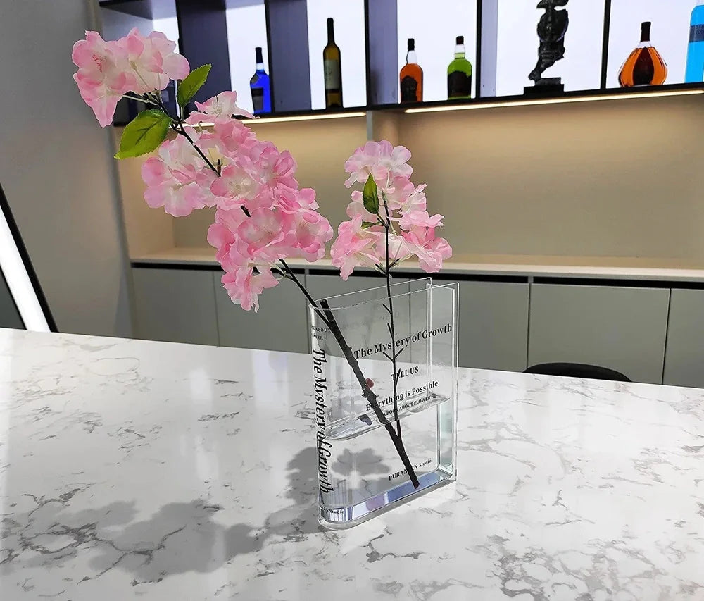Transparent book-shaped acrylic vase, 22cm long with black font, refracting sunlight for home decor
