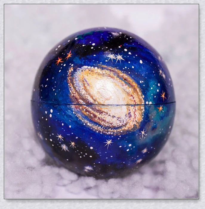 Detailed wooden solar system model with hand-painted planets, astronaut figure, and rocket for interactive space learning and exploration.