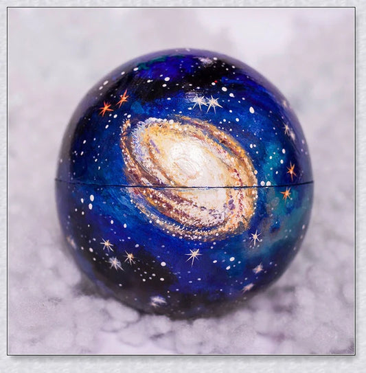 Detailed wooden solar system model with hand-painted planets, astronaut figure, and rocket for interactive space learning and exploration.