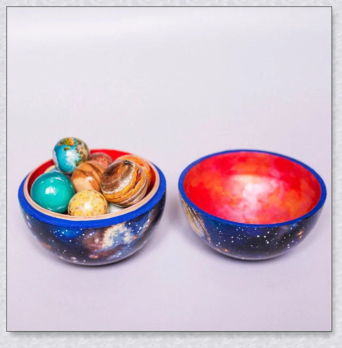 Detailed wooden solar system model with hand-painted planets, astronaut figure, and rocket for interactive space learning and exploration.