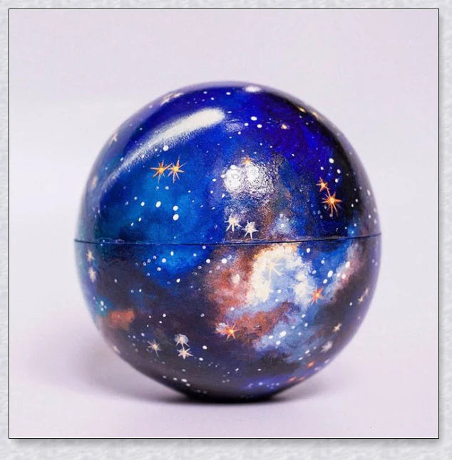 Detailed wooden solar system model with hand-painted planets, astronaut figure, and rocket for interactive space learning and exploration.