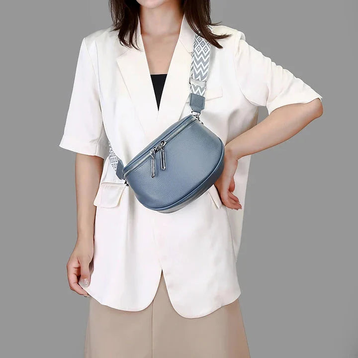 High-quality genuine leather tote bag for women, featuring a beige body with a colorful strap, multiple interior compartments, and a sleek, elegant design.