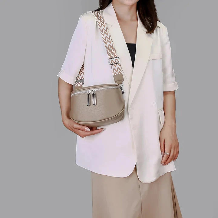 High-quality genuine leather tote bag for women, featuring a beige body with a colorful strap, multiple interior compartments, and a sleek, elegant design.