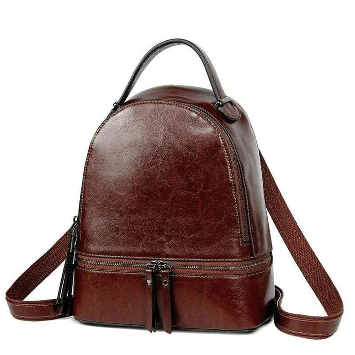 Fashionable leather backpack with cowhide material, multiple pockets, and stylish design elements