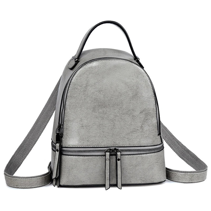 Fashionable leather backpack with cowhide material, multiple pockets, and stylish design elements