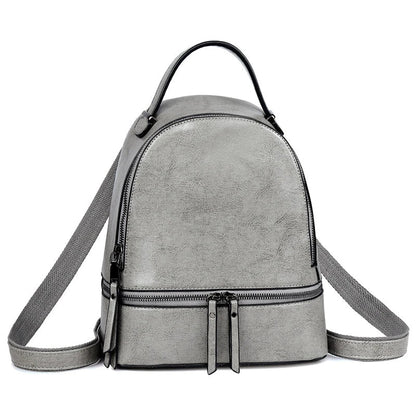Fashionable leather backpack with cowhide material, multiple pockets, and stylish design elements