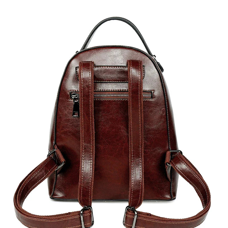 Fashionable leather backpack with cowhide material, multiple pockets, and stylish design elements