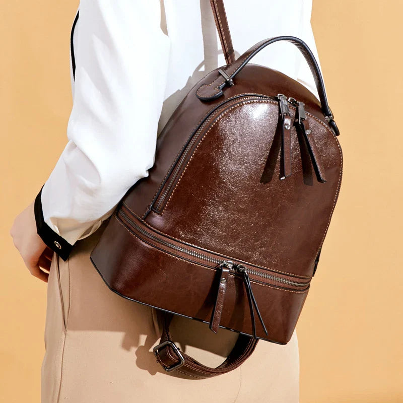 Fashionable leather backpack with cowhide material, multiple pockets, and stylish design elements