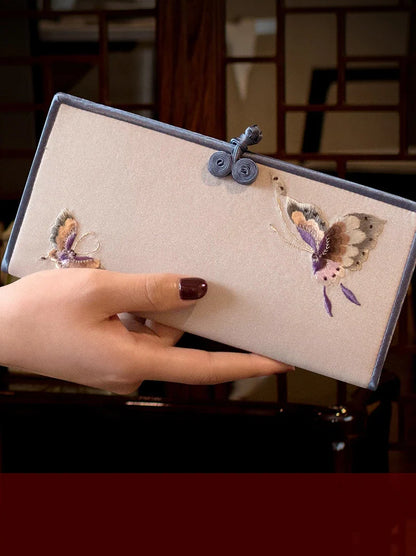 Elegant hand-embroidered long wallet in various colors, featuring a sleek buckle design and ample storage space