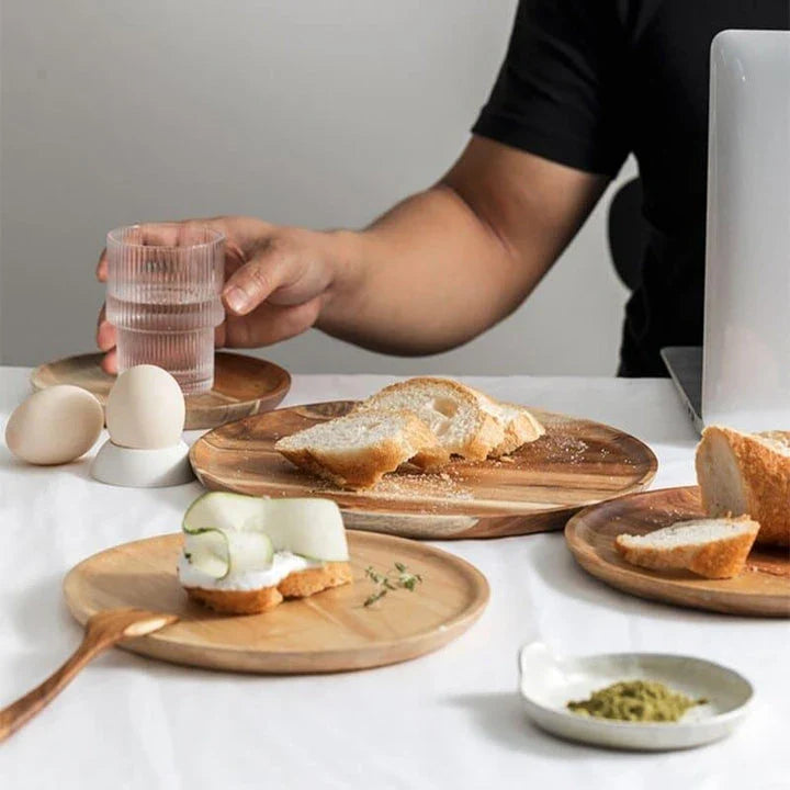 A natural wooden round tray with a sleek, versatile design that complements any home decor.