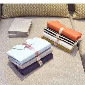Dress Book - Space-Saving Clothes Folder Organizer with pink and gold color options, neatly organizing and storing clothes in a compact, wrinkle-free manner