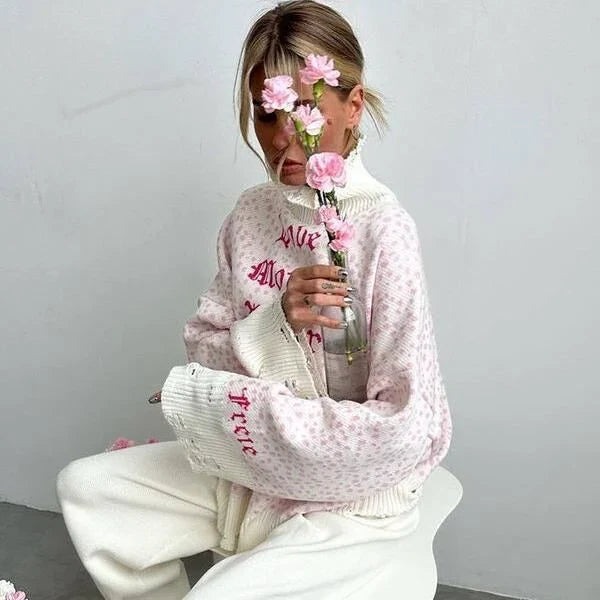 A cozy and stylish embroidered patchwork sweater in a vibrant pink color, perfect for autumn and winter wear.