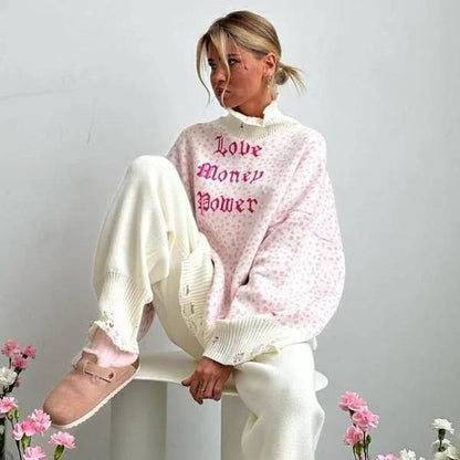 A cozy and stylish embroidered patchwork sweater in a vibrant pink color, perfect for autumn and winter wear.