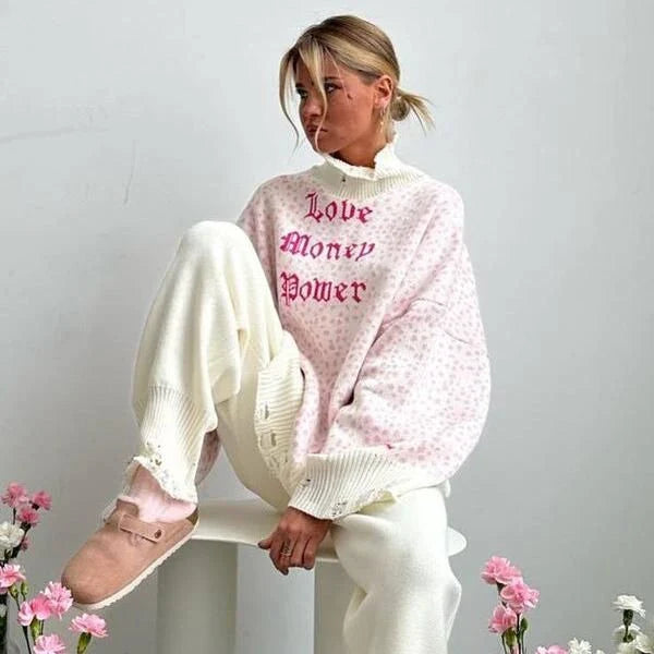 A cozy and stylish embroidered patchwork sweater in a vibrant pink color, perfect for autumn and winter wear.