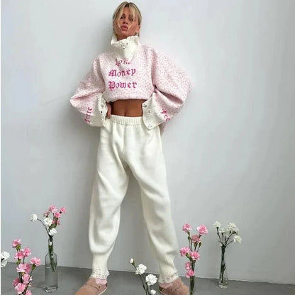 A cozy and stylish embroidered patchwork sweater in a vibrant pink color, perfect for autumn and winter wear.