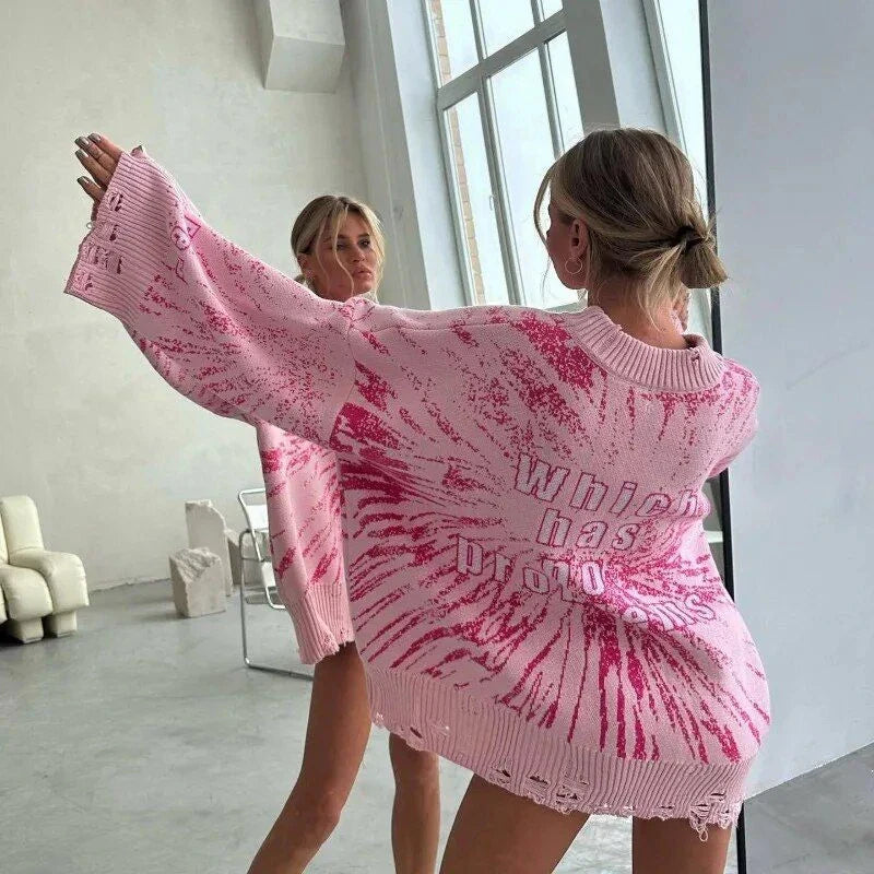 A cozy and stylish embroidered patchwork sweater in a vibrant pink color, perfect for autumn and winter wear.