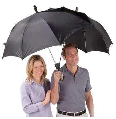Two people sharing an umbrella, staying dry and close together in the rain
