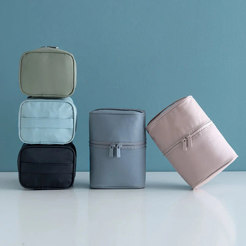 A cylindrical nylon makeup storage bag in a green color, designed for portable and organized beauty on the go.