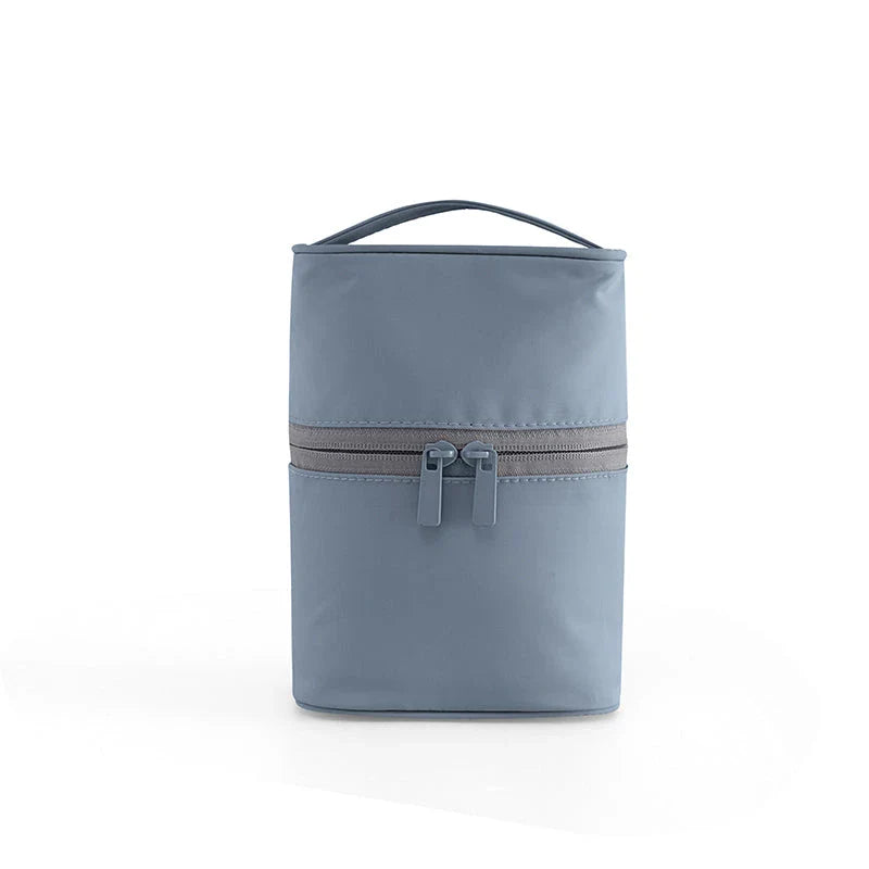 A cylindrical nylon makeup storage bag in a green color, designed for portable and organized beauty on the go.