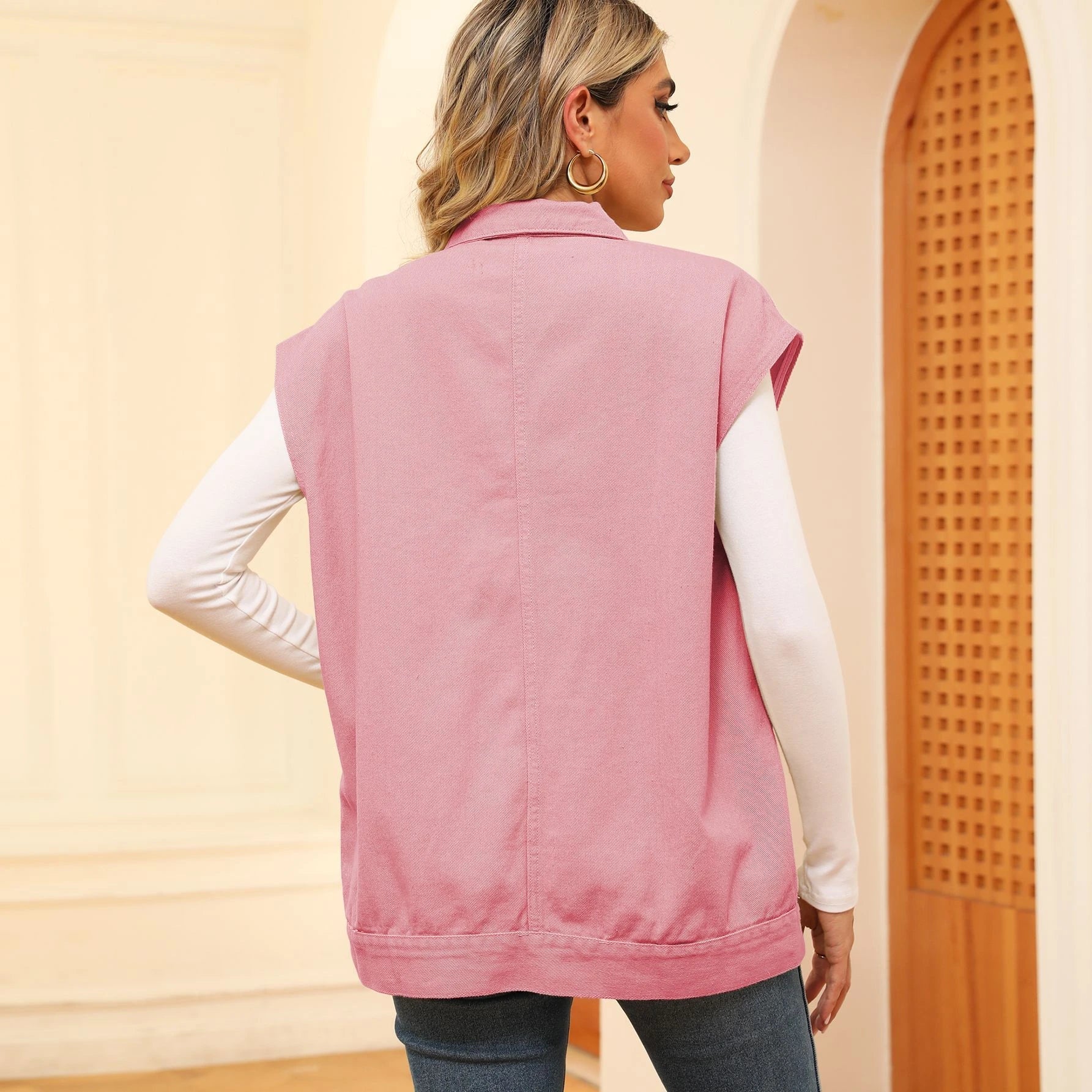 Denim vest with large pockets, sleeveless design, and fashionable silhouette for women's casual and everyday wear