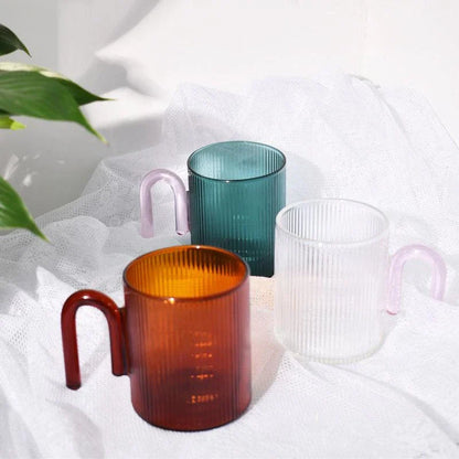 Heat-resistant glass mug with a colorful, corrugated handle for a comfortable grip and stylish appearance