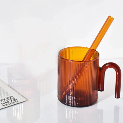 Heat-resistant glass mug with a colorful, corrugated handle for a comfortable grip and stylish appearance