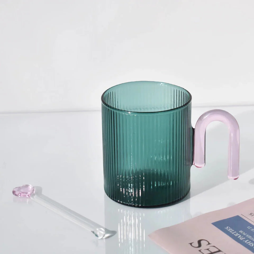 Heat-resistant glass mug with a colorful, corrugated handle for a comfortable grip and stylish appearance
