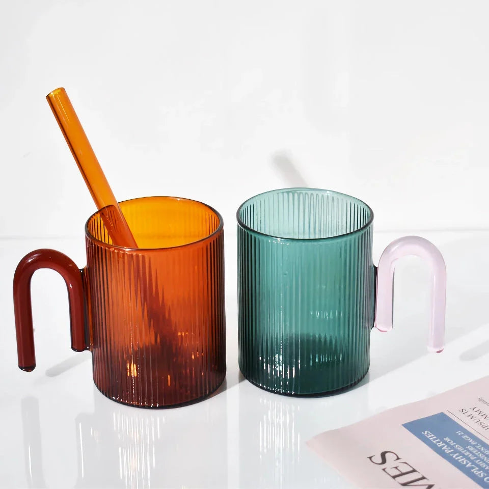 Heat-resistant glass mug with a colorful, corrugated handle for a comfortable grip and stylish appearance