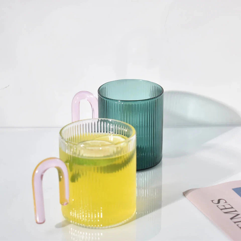 Heat-resistant glass mug with a colorful, corrugated handle for a comfortable grip and stylish appearance
