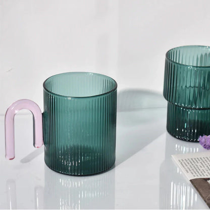 Heat-resistant glass mug with a colorful, corrugated handle for a comfortable grip and stylish appearance