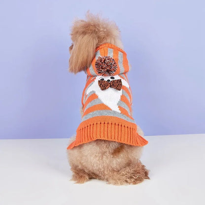 Orange Halloween pet sweater with knitted stripes, fur ball accents, and hood for cats or dogs