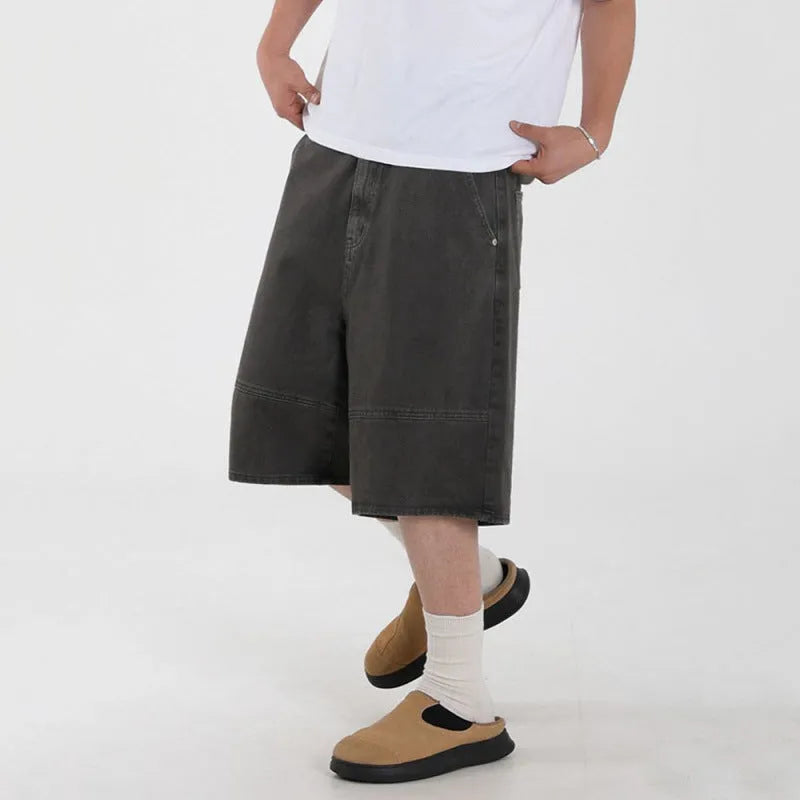 Men's grey loose fit denim shorts with mid waist and zip fly, cropped length, sizes M to 2XL